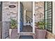 Inviting entryway with stylish brick accents, plants, and an open door view at 312 Concord St, Alpharetta, GA 30009