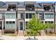 Charming townhome with a private balcony, brick facade, and lush greenery at 312 Concord St, Alpharetta, GA 30009