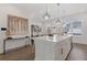 Open-concept kitchen featuring an island with a sink, white cabinets, and pendant lighting at 312 Concord St, Alpharetta, GA 30009