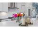 Kitchen island detail featuring flowers, candles, white cabinets, and stainless appliances at 312 Concord St, Alpharetta, GA 30009