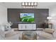 Stylish living room with gray accent wall, contemporary furniture, and a large screen TV at 312 Concord St, Alpharetta, GA 30009