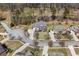 An aerial view of a stately home featuring a manicured lawn and established neighborhood at 7090 Blue Sky Drive, Locust Grove, GA 30248