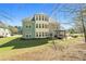 Expansive backyard featuring a well-maintained lawn and inviting patio with outdoor seating at 7090 Blue Sky Drive, Locust Grove, GA 30248