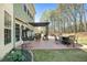 Spacious backyard patio with seating and peaceful wooded views at 7090 Blue Sky Drive, Locust Grove, GA 30248