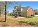 View of the home's backyard with a large patio area, perfect for outdoor entertaining and relaxation at 7090 Blue Sky Drive, Locust Grove, GA 30248