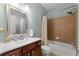 This light-filled bathroom features a single vanity and a shower/tub combo at 7090 Blue Sky Drive, Locust Grove, GA 30248