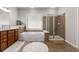Bright bathroom features a double vanity, soaking tub and a separate glass enclosed shower at 7090 Blue Sky Drive, Locust Grove, GA 30248