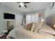 This bedroom features pale blue walls, plush pillows, and large window at 7090 Blue Sky Drive, Locust Grove, GA 30248
