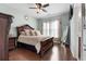 Large bedroom with hardwood floors, ceiling fan, large windows and an ensuite bath at 7090 Blue Sky Drive, Locust Grove, GA 30248