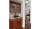 Charming butler's pantry with granite counters, glass cabinets, and modern appliances at 7090 Blue Sky Drive, Locust Grove, GA 30248
