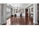 Formal dining room with tray ceilings, dark wood floors, and elegant lighting at 7090 Blue Sky Drive, Locust Grove, GA 30248