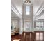 Two-story foyer with dark wood floors, white trim, and abundant natural light at 7090 Blue Sky Drive, Locust Grove, GA 30248