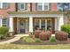 Inviting front porch featuring classic columns and a cozy seating area at 7090 Blue Sky Drive, Locust Grove, GA 30248