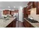 Modern kitchen with granite countertops, stainless steel appliances, and hardwood floors at 7090 Blue Sky Drive, Locust Grove, GA 30248