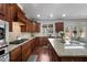 Gourmet kitchen boasting a gas cooktop, hardwood floors, and modern appliances at 7090 Blue Sky Drive, Locust Grove, GA 30248