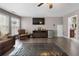 Living room featuring hardwood floors, comfortable seating and a ceiling fan at 7090 Blue Sky Drive, Locust Grove, GA 30248