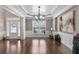 Bright living room featuring hardwood floors, wainscoting detail, and a chandelier at 7090 Blue Sky Drive, Locust Grove, GA 30248