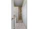 Walk-in shower featuring gray stone look tile and a built-in niche at 7090 Blue Sky Drive, Locust Grove, GA 30248