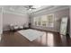 Inviting sitting area boasts hardwood floors, high ceilings, and natural light from many windows at 7090 Blue Sky Drive, Locust Grove, GA 30248