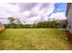 Large backyard featuring lush lawn and peaceful treeline, perfect for outdoor living and recreation at 8245 Dawson View Way, Cumming, GA 30028