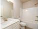 Bathroom with bathtub and shower combination, white tile, and white vanity at 8245 Dawson View Way, Cumming, GA 30028