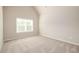 A bedroom with neutral carpet and walls featuring a large window at 8245 Dawson View Way, Cumming, GA 30028