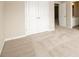 Bedroom includes a large double door closet and neutral carpeting at 8245 Dawson View Way, Cumming, GA 30028
