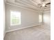 Bedroom with coffered ceiling, carpet and two large windows at 8245 Dawson View Way, Cumming, GA 30028