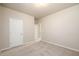 Bedroom includes neutral carpeting, paint, and access to additional rooms at 8245 Dawson View Way, Cumming, GA 30028