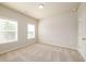Bedroom with natural light features neutral walls, carpeting, and large window at 8245 Dawson View Way, Cumming, GA 30028