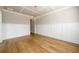 Elegant dining room with hardwood floors, white wainscoting, and a modern chandelier at 8245 Dawson View Way, Cumming, GA 30028
