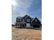 Charming two-story home features navy siding, white trim, and an attached two-car garage at 8245 Dawson View Way, Cumming, GA 30028