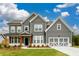 Beautiful two-story home with gray siding, white trim, and a well-manicured lawn at 8245 Dawson View Way, Cumming, GA 30028