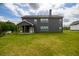 Two-story home exterior with a covered patio and well-maintained lawn, offering a serene outdoor space at 8245 Dawson View Way, Cumming, GA 30028
