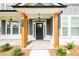 Inviting front entryway with natural wood columns and stone walkway at 8245 Dawson View Way, Cumming, GA 30028