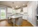 Bright kitchen with granite countertops, a center island, and white cabinetry at 8245 Dawson View Way, Cumming, GA 30028