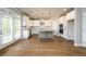 Open kitchen with white cabinets, stainless steel appliances, and a gray island at 8245 Dawson View Way, Cumming, GA 30028