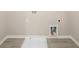 A well-appointed laundry room with tile flooring, perfect for convenience and functionality at 8245 Dawson View Way, Cumming, GA 30028