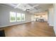 Open-concept living space with hardwood floors, showcasing seamless transition to the kitchen at 8245 Dawson View Way, Cumming, GA 30028