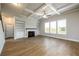 Bright living room with hardwood floors, fireplace, built-in shelving, ceiling fan and lots of natural light at 8245 Dawson View Way, Cumming, GA 30028