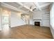 Open living room with wood floors, fireplace, and coffered ceiling, showcasing a warm and inviting space at 8245 Dawson View Way, Cumming, GA 30028