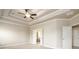 Main bedroom boasts a coffered ceiling, carpet and entry to en-suite at 8245 Dawson View Way, Cumming, GA 30028