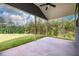 A covered patio offers a relaxing outdoor space with a view of lush greenery and sky at 8245 Dawson View Way, Cumming, GA 30028