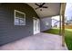 Covered patio with ceiling fan extends living space outdoors, perfect for entertaining or relaxing at 8245 Dawson View Way, Cumming, GA 30028