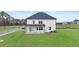Home's backyard features level lot, covered patio, and verdant green grass at 1099 Blue Juniper Cir, Loganville, GA 30052