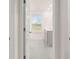 A bright view of a bathroom from the hallway features double sinks and a window for lots of natural light at 1099 Blue Juniper Cir, Loganville, GA 30052