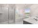 A full glass shower with marble walls, a separate bathtub, and a double sink vanity are highlights of this bathroom at 1099 Blue Juniper Cir, Loganville, GA 30052