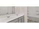 Bathroom with a double sink vanity with gray cabinets, white countertops and a separate toilet room at 1099 Blue Juniper Cir, Loganville, GA 30052