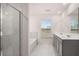 This bathroom features marble flooring, a double sink vanity, a separate shower, and a bathtub under a window at 1099 Blue Juniper Cir, Loganville, GA 30052