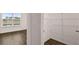 Walk-in closet with ample shelving and window in the bedroom at 1099 Blue Juniper Cir, Loganville, GA 30052